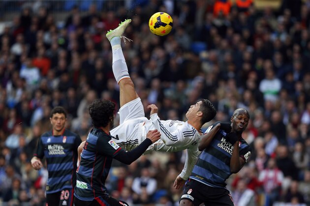 FILE - In this Saturday, Jan. 25, 2014 file photo Real Madrid's Cristiano Ronaldo, of Portugal, top, tries to score in between opposition players during a Spanish La Liga soccer match between Real Madrid and Granada at the Santiago Bernabeu stadium in Madrid, Spain. (AP Photo/Andres Kudacki, File)