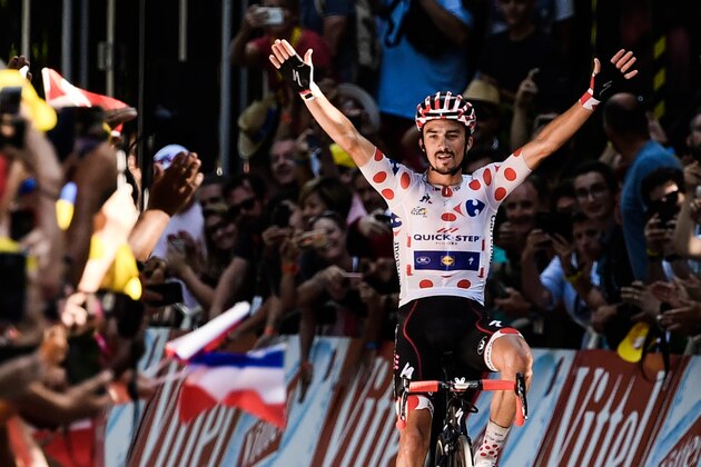 France's Julian Alaphilippe, wearing the best climber's polka dot jersey, celebrates as he crosses the finish line to win the 16th stage of the 105th edition of the Tour de France cycling race, between Carcassonne and Bagneres-de-Luchon, southwestern France, on July 24, 2018. (Photo by Philippe LOPEZ / AFP) / ALTERNATIVE CROP        (Photo credit should read PHILIPPE LOPEZ/AFP/Getty Images)