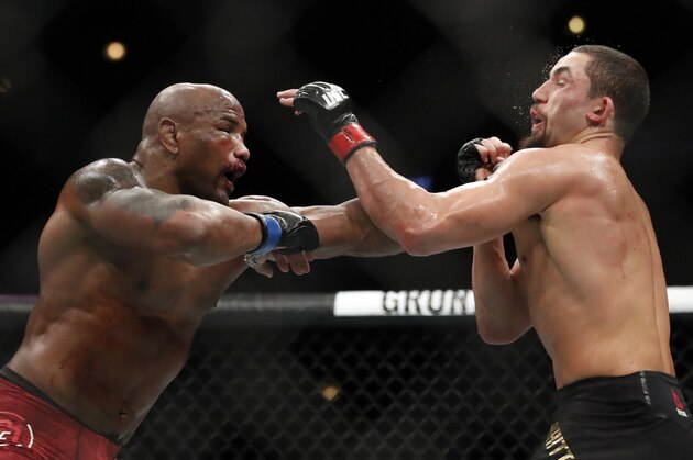 Robert Whittaker, right, and Yoel Romero fight during their middleweight Title bout at the UFC 225 Mixed Martial Arts event Sunday, June 10, 2018, in Chicago. (AP Photo/Jim Young)