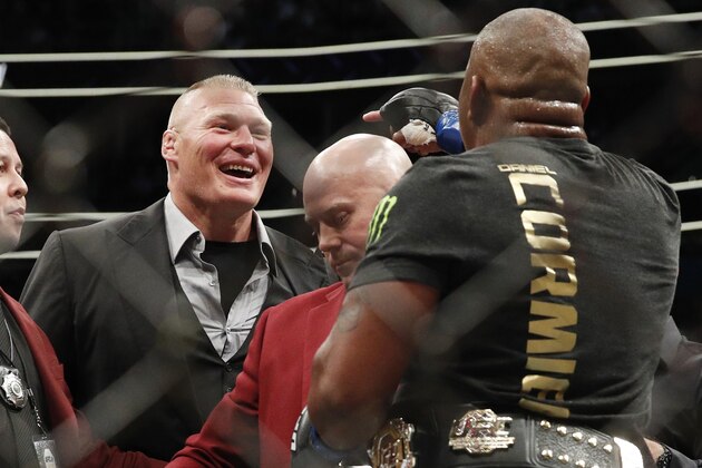 Brock Lesnar, left, taunts Daniel Cormier after Cormier's heavyweight title mixed martial arts bout at against Stipe Miocic at UFC 226, Saturday, July 7, 2018, in Las Vegas. (AP Photo/John Locher)