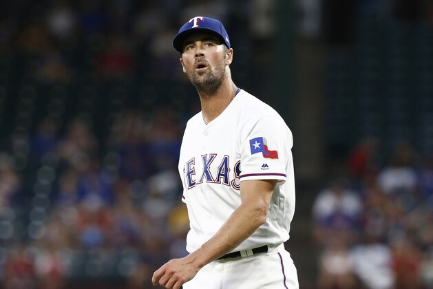Texas Rangers starting pitcher Cole Hamels reacts after giving up a two-run home run to Oakland Athletics' Stephen Piscotty during the fifth inning of a baseball game Monday, July 23, 2018, in Arlington, Texas. (AP Photo/Mike Stone)