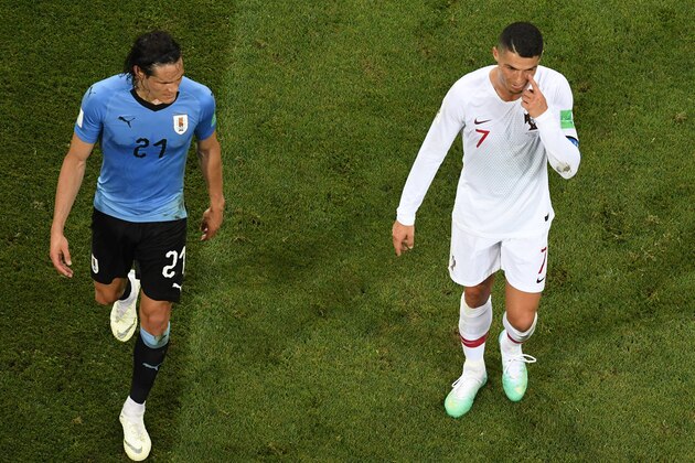 TOPSHOT - Portugal's forward Cristiano Ronaldo (R) gestures next to Uruguay's forward Edinson Cavani during the Russia 2018 World Cup round of 16 football match between Uruguay and Portugal at the Fisht Stadium in Sochi on June 30, 2018. (Photo by Kirill KUDRYAVTSEV / AFP) / RESTRICTED TO EDITORIAL USE - NO MOBILE PUSH ALERTS/DOWNLOADS        (Photo credit should read KIRILL KUDRYAVTSEV/AFP/Getty Images)