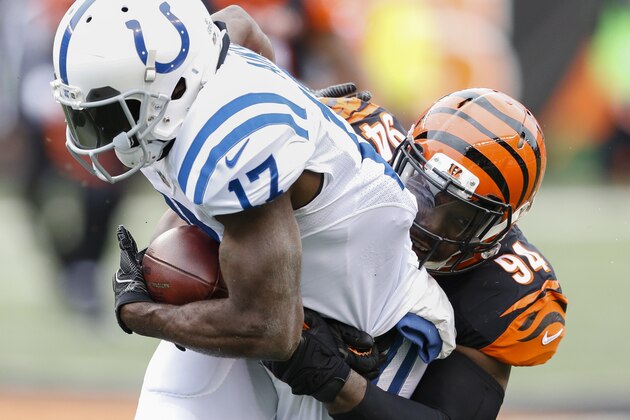 Cincinnati Bengals defensive end Chris Smith (94) tackles Indianapolis Colts wide receiver Kamar Aiken (17) in the first half of an NFL football game, Sunday, Oct. 29, 2017, in Cincinnati. (AP Photo/Gary Landers)
