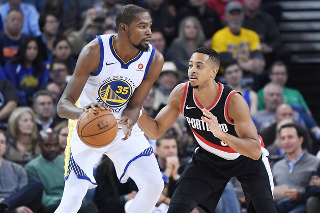 OAKLAND, CA - DECEMBER 11:  Kevin Durant #35 of the Golden State Warriors dribbling the ball backs in on CJ McCollum #3 of the Portland Trail Blazers during an NBA basketball game at ORACLE Arena on December 11, 2017 in Oakland, California. NOTE TO USER: User expressly acknowledges and agrees that, by downloading and or using this photograph, User is consenting to the terms and conditions of the Getty Images License Agreement.  (Photo by Thearon W. Henderson/Getty Images)