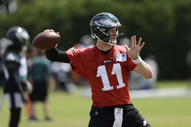 In this June 7, 2018, photo, Philadelphia Eagles' Carson Wentz runs a drill during an organized team activity at the NFL football team's practice facility in Philadelphia. Wentz and his longtime girlfriend Maddie Oberg were wed at the Lake House Inn in Bucks County on Sunday, July 15, and kayakers and canoers on Lake Nockamixon were treated to a waterside view of the nuptials. (AP Photo/Matt Slocum)