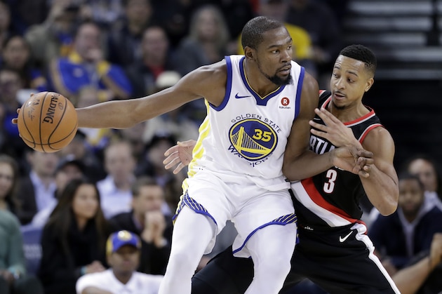 Golden State Warriors' Kevin Durant (35) is defended by Portland Trail Blazers' CJ McCollum (3) during the second half of an NBA basketball game Monday, Dec. 11, 2017, in Oakland, Calif. The Warriors won, 111-104. (AP Photo/Marcio Jose Sanchez)
