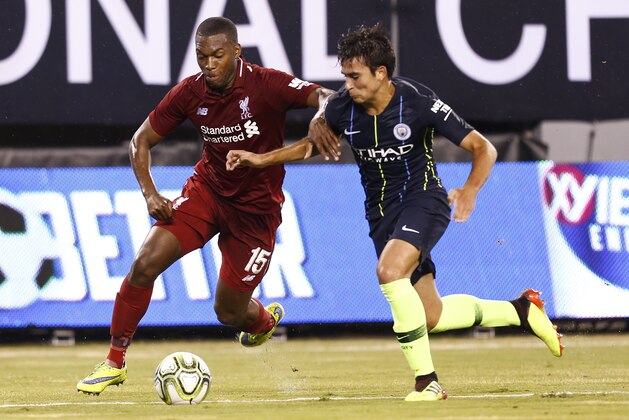 EAST RUTHERFORD, NJ - JULY 25: Daniel Sturridge #15 of Liverpool fights for the ball with Brahim Diaz #55 of Manchester City during their match at MetLife Stadium on July 25, 2018 in East Rutherford, New Jersey. (Photo by Jeff Zelevansky/Getty Images)