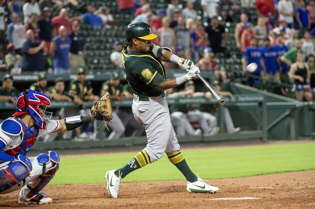 CORRECTS TO NINTH INNING, INSTEAD OF EIGHTH - Oakland Athletics' Khris Davis hits a two-run home run off Texas Rangers relief pitcher Jose Leclerc during the ninth inning of a baseball game Wednesday, July 25, 2018, in Arlington, Texas. Oakland won 6-5. (AP Photo/Jeffrey McWhorter)