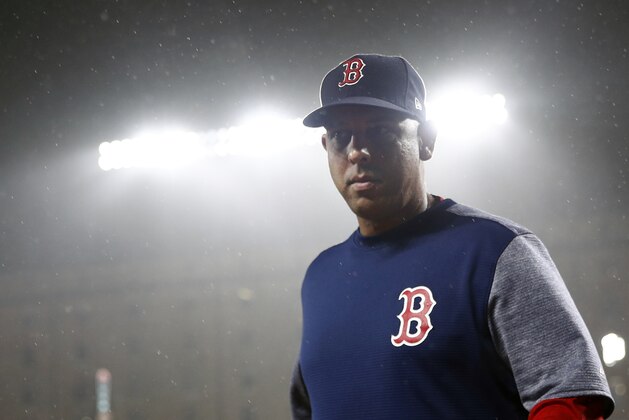 Boston Red Sox manager Alex Cora walks on the field as rain falls during a baseball game against the Baltimore Orioles, Tuesday, July 24, 2018, in Baltimore. (AP Photo/Patrick Semansky)