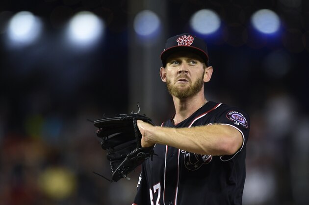 Washington Nationals starting pitcher Stephen Strasburg pauses between throws during the fifth inning of a baseball game against the Atlanta Braves at Nationals Park in Washington, Friday, July 20, 2018. (AP Photo/Susan Walsh)