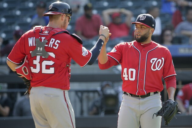 Washington Nationals relief pitcher Kelvin Herrera, right, and catcher Jamie Burke celebrate after the baseball game against the New York Mets at Citi Field, Sunday, July 15, 2018, in New York. The Nationals defeated the Mets 6-1. (AP Photo/Seth Wenig)