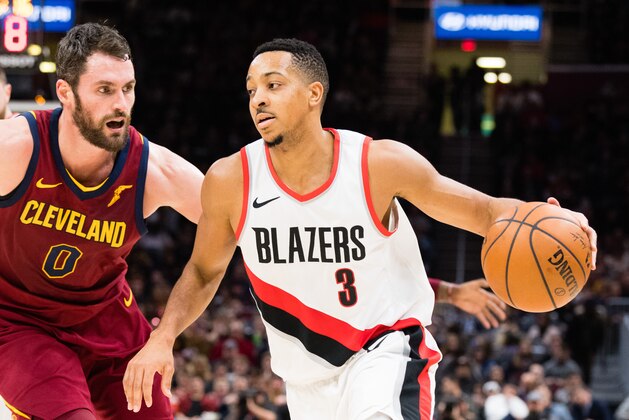 CLEVELAND, OH - JANUARY 2: Kevin Love #0 of the Cleveland Cavaliers tries to stop CJ McCollum #3 of the Portland Trail Blazers during the second half at Quicken Loans Arena on January 2, 2018 in Cleveland, Ohio. The Cavaliers defeated the Trail Blazers 127-110. NOTE TO USER: User expressly acknowledges and agrees that, by downloading and or using this photograph, User is consenting to the terms and conditions of the Getty Images License Agreement. (Photo by Jason Miller/Getty Images)