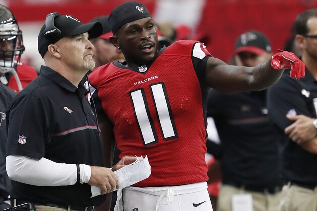 Atlanta Falcons head coach Dan Quinn speaks with Atlanta Falcons wide receiver Julio Jones (11) on the sidelines against the Tampa Bay Buccaneers during the first half of an NFL football game, Sunday, Sept. 11, 2016, in Atlanta. (AP Photo/John Bazemore)