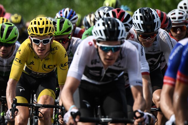 Great Britain's Geraint Thomas (L), wearing the overall leader's yellow jersey, and Great Britain's Christopher Froome (Rear R) ride in the pack during the 18th stage of the 105th edition of the Tour de France cycling race, on July 26, 2018 between Trie-sur-Baise and Pau, southwestern France. (Photo by Jeff PACHOUD / AFP)        (Photo credit should read JEFF PACHOUD/AFP/Getty Images)