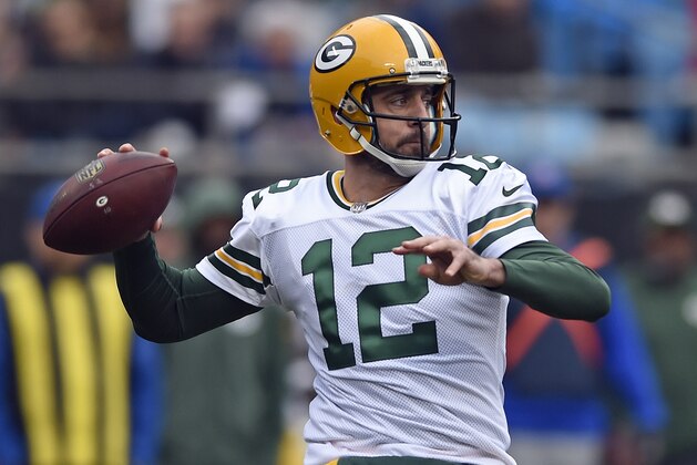 FILE - In this Dec. 17, 2017, file photo, Green Bay Packers' Aaron Rodgers looks to pass against the Carolina Panthers during the first half of an NFL football game in Charlotte, N.C. The Green Bay Packers opened on-field work in their offseason program this week, an especially important time for a team that has had a lot of changes since the end of a 7-9 season. On offense, Aaron Rodgers is healthy again after missing much of last season with a broken collarbone.. (AP Photo/Mike McCarn, File)