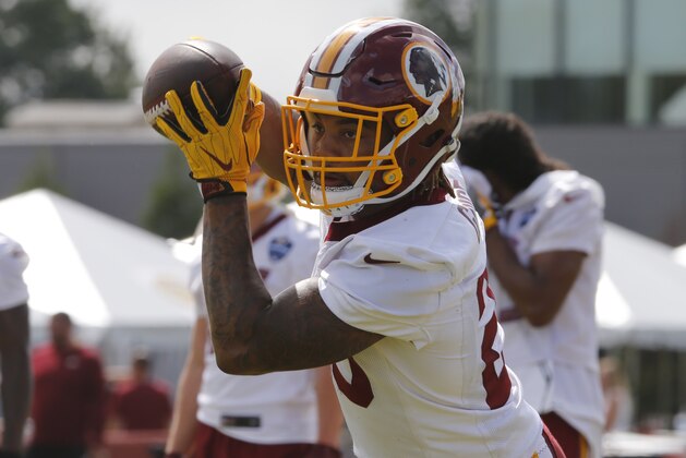Washington Redskins running back Derrius Guice hauls in a pass during drills at the start of the Redskins NFL football training camp in Richmond, Va., Thursday, July 26, 2018. (AP Photo/Steve Helber)