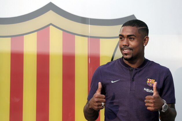 Brazilian soccer player Malcom Filipe Silva de Oliveira poses for the media upon his arrival at the club's office at the Camp Nou stadium in Barcelona, Tuesday, July 24, 2018. Malcom has signed a five-year deal. (AP Photo/Manu Fernandez)
