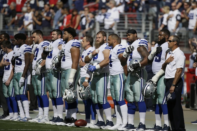 Dallas Cowboys players stand during the performance of the national anthem before an NFL football game against the San Francisco 49ers in Santa Clara, Calif., Sunday, Oct. 22, 2017. (AP Photo/Eric Risberg)