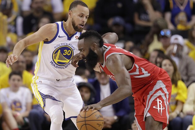 Houston Rockets guard James Harden, right, drives against Golden State Warriors guard Stephen Curry (30) during the second half of Game 3 of the NBA basketball Western Conference Finals in Oakland, Calif., Sunday, May 20, 2018. (AP Photo/Marcio Jose Sanchez)