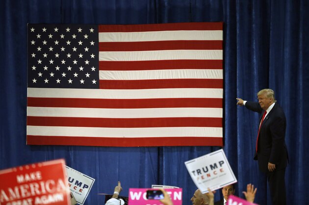 Republican presidential candidate Donald Trump points to the American flag after speaking at a campaign rally at the University of Northern Colorado, in Greeley, Colo., Sunday, Oct. 30, 2016. (AP Photo/ Brennan Linsley)