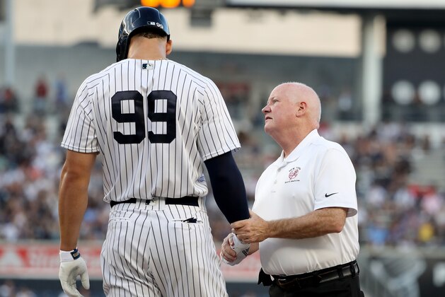 NEW YORK, NY - JULY 26:  Aaron Judge #99 of the New York Yankees is looked at after he was hit by a pitch in the first inning against the Kansas City Royals at Yankee Stadium on July 26, 2018 in the Bronx borough of New York City.  (Photo by Elsa/Getty Images)