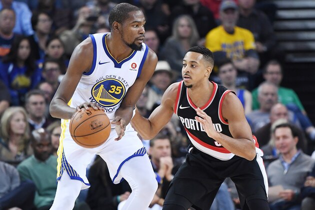 OAKLAND, CA - DECEMBER 11:  Kevin Durant #35 of the Golden State Warriors dribbling the ball backs in on CJ McCollum #3 of the Portland Trail Blazers during an NBA basketball game at ORACLE Arena on December 11, 2017 in Oakland, California. NOTE TO USER: User expressly acknowledges and agrees that, by downloading and or using this photograph, User is consenting to the terms and conditions of the Getty Images License Agreement.  (Photo by Thearon W. Henderson/Getty Images)