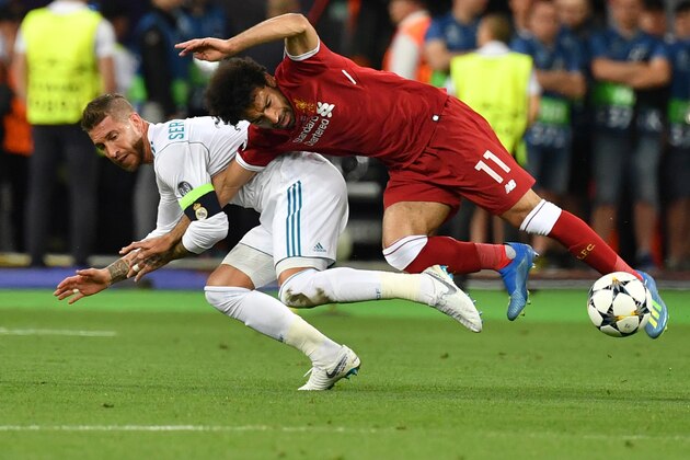 TOPSHOT - Liverpool's Egyptian forward Mohamed Salah (R) falls with Real Madrid's Spanish defender Sergio Ramos leading to Salah being injured during the UEFA Champions League final football match between Liverpool and Real Madrid at the Olympic Stadium in Kiev, Ukraine, on May 26, 2018. (Photo by GENYA SAVILOV / AFP)        (Photo credit should read GENYA SAVILOV/AFP/Getty Images)