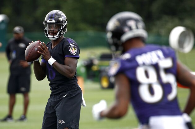 Baltimore Ravens quarterback Lamar Jackson, left, runs a drill during an NFL football training camp practice at the team's headquarters, Monday, July 23, 2018, in Owings Mills, Md. (AP Photo/Patrick Semansky)