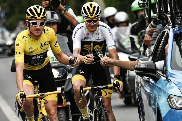 Great Britain's Geraint Thomas (L)  wearing the overall leader's yellow jersey, Great Britain's Christopher Froome (C) and Great Britain Team Sky team principal, Sir Dave Brailsford (R) drink  champagne during the 21st and last stage of the 105th edition of the Tour de France cycling race between Houilles and Paris Champs-Elysees, on July 29, 2018. (Photo by Marco BERTORELLO / POOL / AFP)        (Photo credit should read MARCO BERTORELLO/AFP/Getty Images)