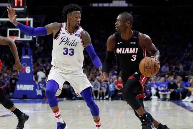 Miami Heat's Dwyane Wade, right, makes a move against Philadelphia 76ers' Robert Covington, left, during the first half in Game 1 of a first-round NBA basketball playoff series Saturday, April 14, 2018, in Philadelphia. (AP Photo/Chris Szagola)