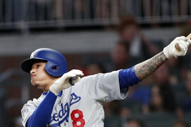 Los Angeles Dodgers shortstop Manny Machado (8) hits a solo-home run in the sixth inning of a baseball game against Atlanta Braves Thursday, July 26, 2018 in Atlanta. (AP Photo/John Bazemore)
