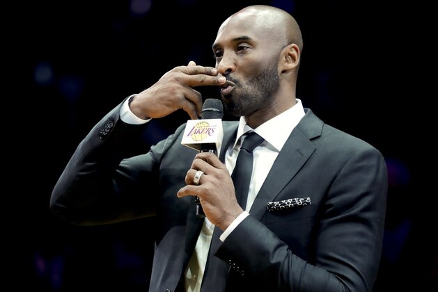 Former Los Angeles Laker Kobe Bryant speaks during a halftime ceremony retiring both of his jersey's during an NBA basketball game between the Los Angeles Lakers and the Golden State Warriors in Los Angeles, Monday, Dec. 18, 2017. (AP Photo/Chris Carlson)