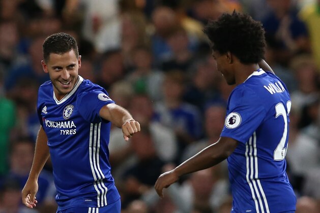 Chelsea's Belgian midfielder Eden Hazard (L) celebrates with Chelsea's Brazilian midfielder Willian (R) after scoring the opening goal from the penalty spot during the English Premier League football match between Chelsea and West Ham United at Stamford Bridge in London on August 15, 2016. / AFP / Justin TALLIS / RESTRICTED TO EDITORIAL USE. No use with unauthorized audio, video, data, fixture lists, club/league logos or 'live' services. Online in-match use limited to 75 images, no video emulation. No use in betting, games or single club/league/player publications.  /         (Photo credit should read JUSTIN TALLIS/AFP/Getty Images)