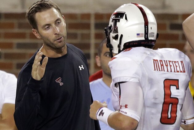 Texas Tech head coach Kliff Kingsbury, left, congratulates quarterback Baker Mayfield (6) after he scored a touchdown during the second half of an NCAA college football game against Southern Methodist Friday, Aug. 30, 2013, in Dallas. Texas Tech won 41-23. (AP Photo/LM Otero)