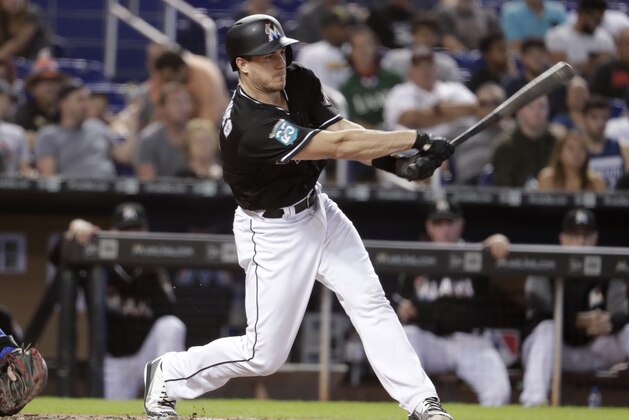 Miami Marlins' J.T. Realmuto bats during a baseball game against the New York Mets, Saturday, June 30, 2018, in Miami. (AP Photo/Lynne Sladky)