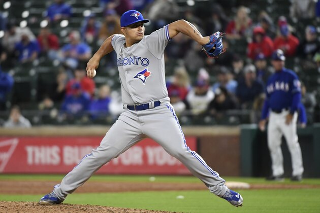 Toronto Blue Jays relief pitcher Roberto Osuna works against the Texas Rangers in the ninth inning of a baseball game Friday, April 6, 2018, in Arlington, Texas. Toronto won 8-5. (AP Photo/Jeffrey McWhorter)