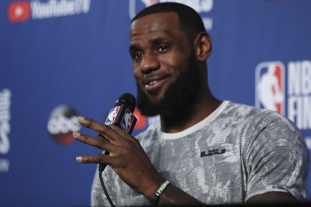 Cleveland Cavaliers forward LeBron James takes questions at a press conference after the basketball team's practiced during the NBA Finals, Thursday, June 7, 2018, in Cleveland. The Warriors lead the series 3-0 with Game 4 on Friday. (AP Photo/Carlos Osorio)
