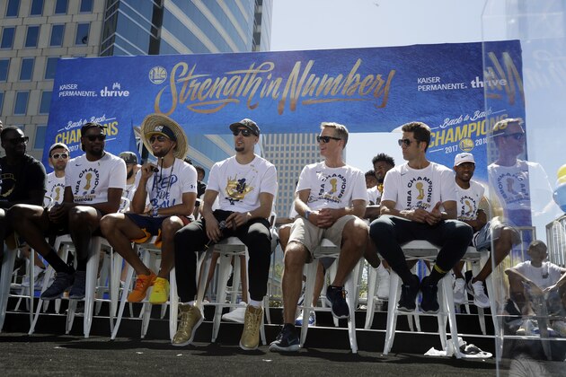 Members of the Golden State Warriors, from left, Draymond Green, Kevin Durant, Stephen Curry, Klay Thompson, head coach Steve Kerr and general manager Bob Myers gather before the team's NBA basketball championship parade, Tuesday, June 12, 2018, in Oakland, Calif. (AP Photo/Marcio Jose Sanchez)