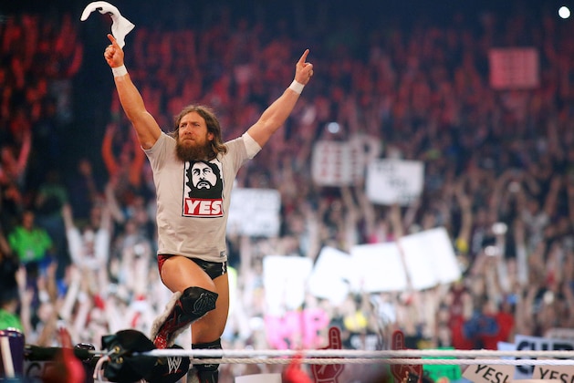 In this April 6, 2014 photo, Daniel Bryan reacts during Wrestlemania XXX at the Mercedes-Benz Super Dome in New Orleans. Bryan was on top of the wrestling world when he won the WWE championship at WrestleMania in 2014. But he is finished just two years later at 35, a victim of at least 10 concussions that ended his career and showed how real-life injuries interrupt fantasy endings.  (Jonathan Bachman/AP Images for WWE)