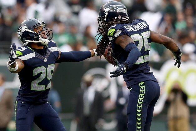 EAST RUTHERFORD, NJ - OCTOBER 02:   Earl Thomas #29 of the Seattle Seahawks celebrates with teammate Richard Sherman #25 after Thomas intercepted a pass in the second half against the New York Jets at MetLife Stadium on October 2, 2016 in East Rutherford, New Jersey.  (Photo by Elsa/Getty Images)