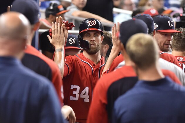 MIAMI, FL - JULY 28: Bryce Harper #34 of the Washington Nationals is congratulated by teammates after scoring the tying run in the ninth inning against the Miami Marlins at Marlins Park on July 28, 2018 in Miami, Florida. (Photo by Eric Espada/Getty Images)
