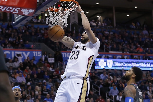 New Orleans Pelicans forward Anthony Davis (23) dunks between Oklahoma City Thunder forward Carmelo Anthony (7) and center Steven Adams (12) during the first half of an NBA basketball game in Oklahoma City, Friday, Feb. 2, 2018. (AP Photo/Sue Ogrocki)