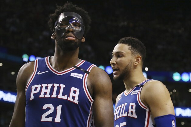Philadelphia 76ers center Joel Embiid (21) and guard Ben Simmons (25) have words during a break in the fourth quarter of Game 2 of an NBA basketball second-round playoff series against the Boston Celtics, Thursday, May 3, 2018, in Boston. (AP Photo/Elise Amendola)