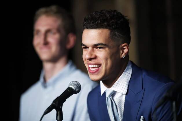 FILE - In this June 22, 2018, file photo, Michael Porter Jr., the Denver Nuggets first-round pick in the NBA Draft, jokes with reporters as one of the team's two, second-round selections, Thomas Welsh, looks on during a news conference to introduce the players to the media, in Denver. Nuggets rookie forward Michael Porter Jr. has undergone back surgery in Dallas and there is no timetable for his return to the court. The team said Thursday, July 19, 2018, the procedure of the lumbar spine was performed by Dr. Andrew Dossett at the Carrell Clinic. (AP Photo/David Zalubowski, File)