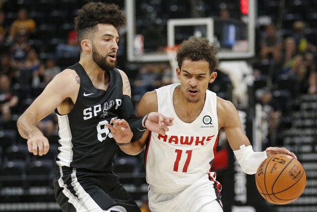 Atlanta Hawks guard Trae Young (11) drives around San Antonio Spurs guard London Perrantes, left, during the first half of an NBA summer league basketball game Tuesday, July 3, 2018, in Salt Lake City. (AP Photo/Rick Bowmer)
