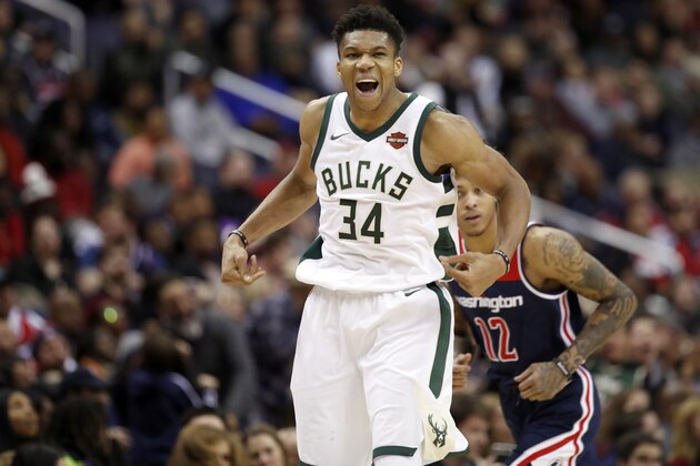 Milwaukee Bucks forward Giannis Antetokounmpo (34), from Greece, celebrates after making a shot over Washington Wizards forward Kelly Oubre Jr. (12) during the second half of an NBA basketball game Saturday, Jan. 6, 2018, in Washington. The Bucks won 110-103. (AP Photo/Alex Brandon)