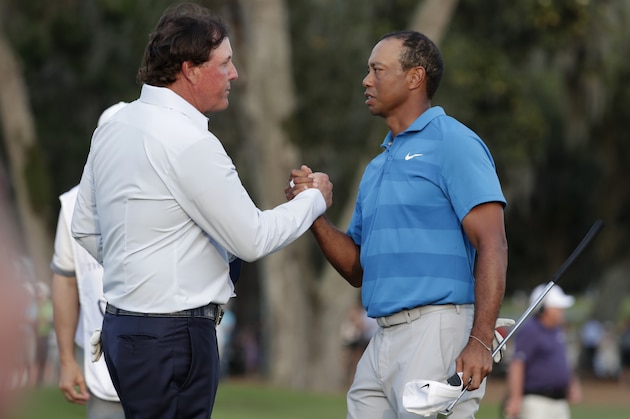 Phil Mickelson, left, and Tiger Woods shake hands after the first round of the Players Championship golf tournament Thursday, May 10, 2018, in Ponte Vedra Beach, Fla. (AP Photo/Lynne Sladky)