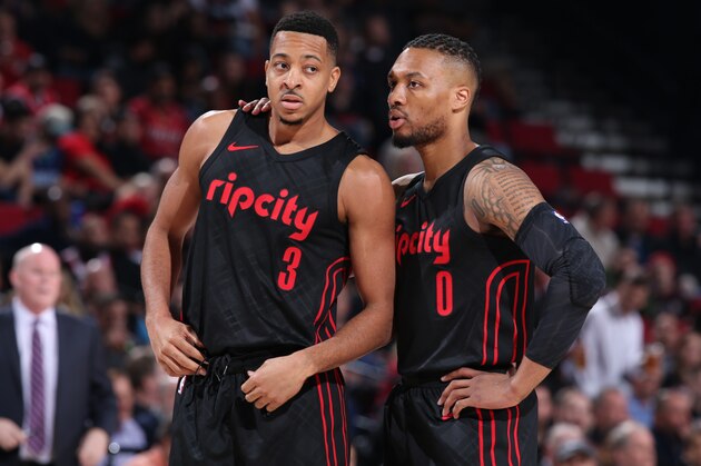 PORTLAND, OR - FEBRUARY 8:  Damian Lillard #0 speaks to CJ McCollum of the Portland Trail Blazers during the game against the Charlotte Hornets on February 8, 2018 at the Moda Center Arena in Portland, Oregon. NOTE TO USER: User expressly acknowledges and agrees that, by downloading and or using this photograph, user is consenting to the terms and conditions of the Getty Images License Agreement. Mandatory Copyright Notice: Copyright 2018 NBAE (Photo by Sam Forencich/NBAE via Getty Images)