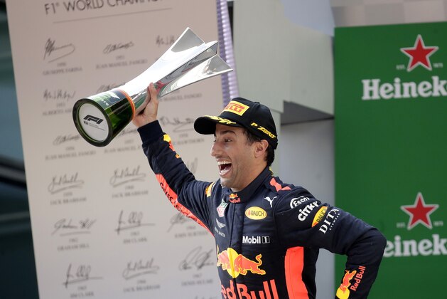 Red Bull driver Daniel Ricciardo of Australia celebrates with his trophy after winning the Chinese Formula One Grand Prix at the Shanghai International Circuit in Shanghai, Sunday, April 15, 2018. (AP Photo/Andy Wong)