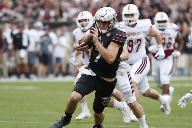 Mississippi State quarterback Nick Fitzgerald (7) runs past Massachusetts defenders in the first half of an NCAA college football game in Starkville, Miss., Saturday, Nov. 4, 2017. No. 21 Mississippi State won 34-23. (AP Photo/Rogelio V. Solis)